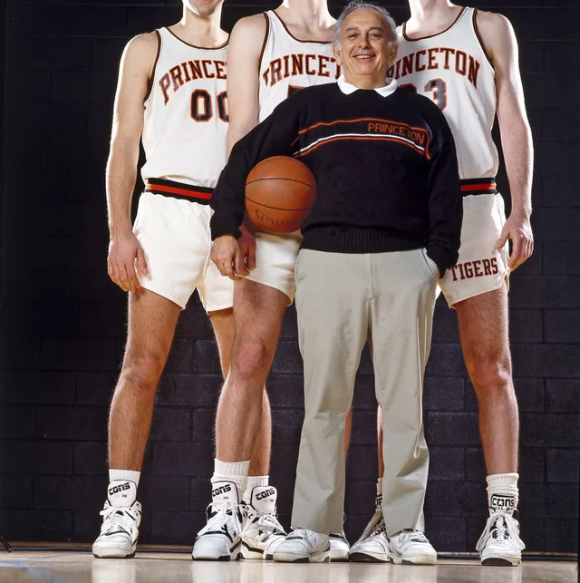 A picture of Coach Pete Carril with three Princeton basketball players.